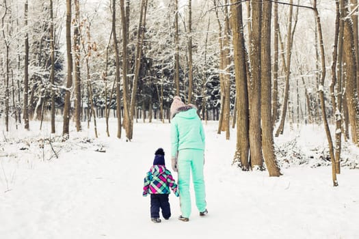 Little girl and her mom having fun on a winter day.