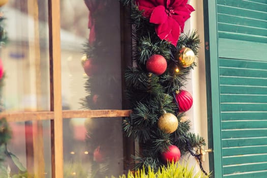 Christmas Red ball decorated windows on vintage house.