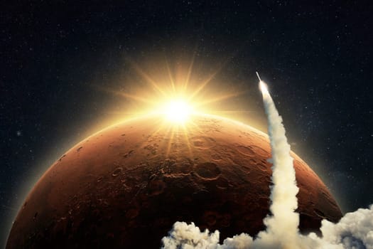 New space shuttle rocket with a blast and smoke takes off into space on background of the red planet Mars and sunrise light. Concept of technology and travel to Mars. Spaceship lift off