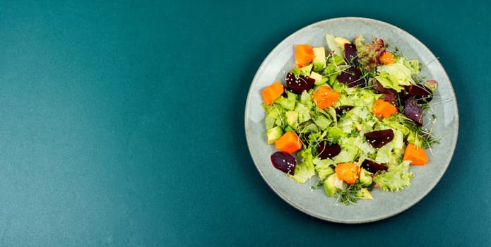 Autumn vegetarian salad of baked pumpkin, beetroot and greens. Top view with copy space.