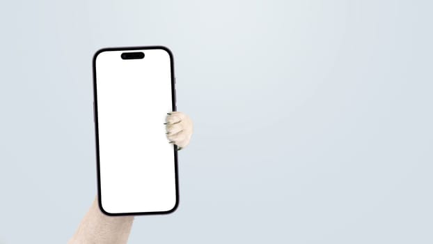 Dog paw holding smartphone mock up on isolated background. Smartphone, creative idea. Funny animal shows the phone