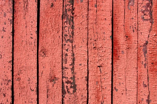 Vintage wooden texture with old paint. Cracked paint is on wooden background.