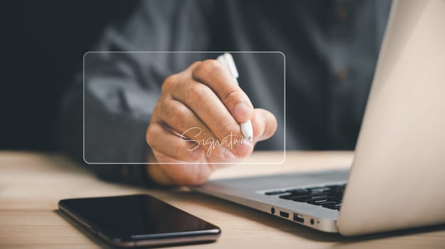 Businessman using digital device signs electronic documents online. Embracing digital transformation, represents efficiency of e-signing, digital document management. Agreement is finalized.