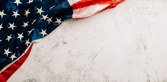 Celebrate Veteran's Day with a vintage US flag, a powerful symbol of American honor, pride, and unity. Patriotic stars and stripes stand for the government. isolated on cement background