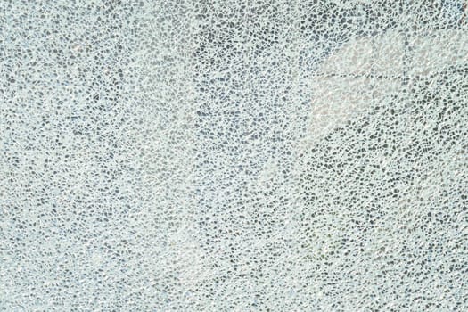 Broken reinforced, hardened or laminated glass to little pieces like mosaic. Cracked glass on white background. High resolution abstract texture