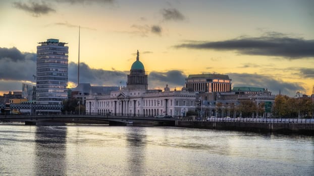 Beautiful 18th century Custom House Visitor Centre with SIPTU College and Spire in background, next to Liffey River, Dublin, Ireland
