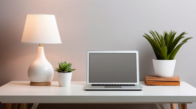 A minimalist workspace, white desk with a potted succulents, table lamp and laptop computer. AI generated