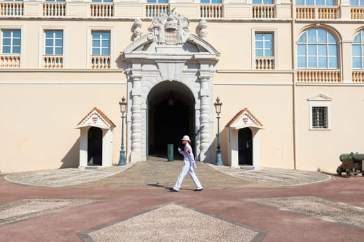 Monte Carlo - August 2022: guard with Summer uniform walking in front of the Royal Palace