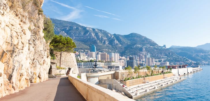 Monte Carlo - August 2022: promenade in front of the sea. Blue sky on scenery seascape. Concept of travel, adventure, freedom