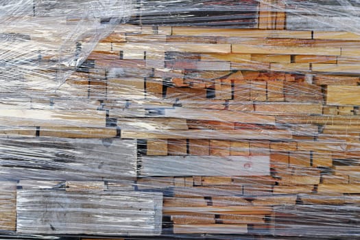 Wooden boards wrapped in foil waiting to be processed