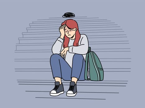 Teenage woman cries because of bullying or harassment and sits on steps suffering from social problems. Upset girl needs psychological support to overcome complexes caused by bullying in college