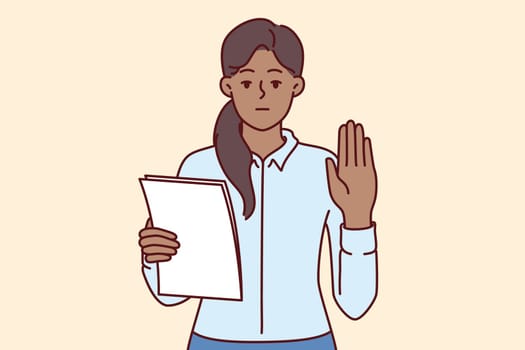 Woman makes solemn oath holding documents with text of inauguration and showing palm as sign of sincerity. Ethnic girl takes oath before taking office as senator or representative of parliament