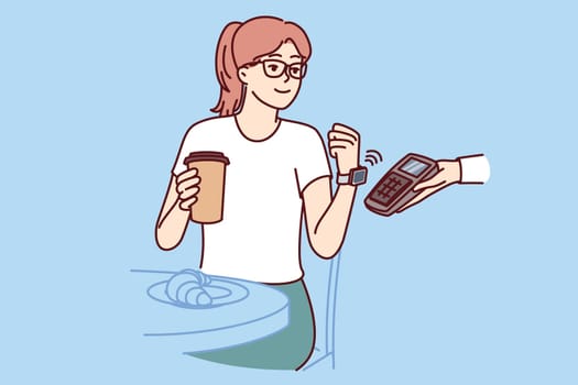 Woman makes contactless payment with smart watch, applying gadget with NFC chip to POS terminal in hand waiter from cafe. Girl has breakfast in restaurant and drinks coffee, making payment
