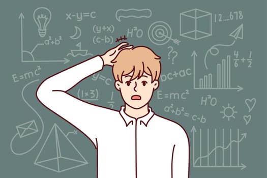 Embarrassed guy student studying mathematics, scratching back of head standing near school chalkboard after making mistake. Stupid male student failed to prove mathematical theorem and pass exam