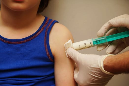 Doctor gives a child an injection