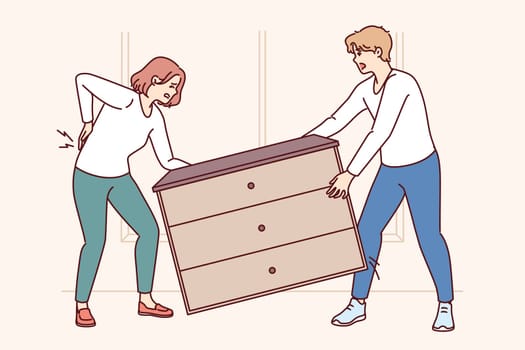 Woman injured back while rearranging furniture in house with husband or moving to new apartment. Girl got spinal injury trying to lift heavy wardrobe and save on movers during moving