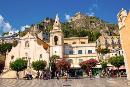 Sicily, Taormina, Italy - 28 September 2023. City views, facades, architecture and the most popular streets. Tourists at Mainsquare Piazza IX Aprile and San Giuseppe church.