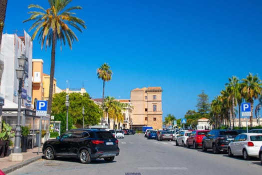 Milazzo, Sicily, Italy - 03 October 2023. The Via Ammiraglio Luigi Rizzo road runs alongside the Liberty Lines ferry port. In background the city Hall of Milazzo.