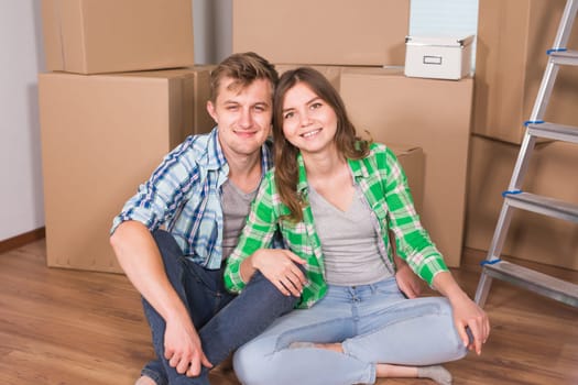 Home, people, moving and real estate concept - Portrait of happy couple in new home.