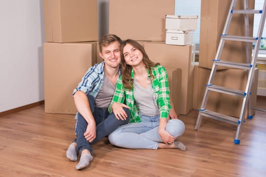 Home, people, moving and real estate concept - Portrait of happy couple in new home.