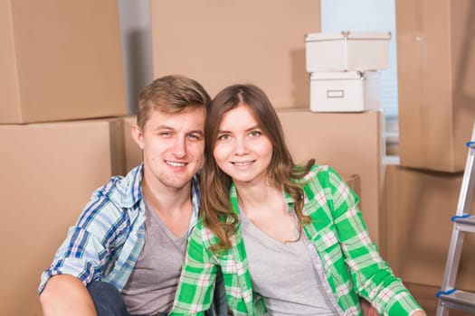 Home, people, moving and real estate concept - Portrait of happy couple in new home.