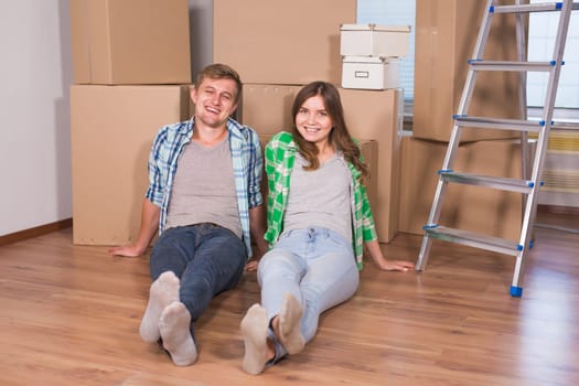 Home, people, moving and real estate concept - Portrait of happy couple in new home.