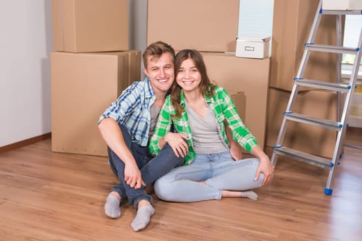 Home, people, moving and real estate concept - Portrait of happy couple in new home.