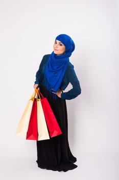 Arab or Muslim woman with shopping bags on white background