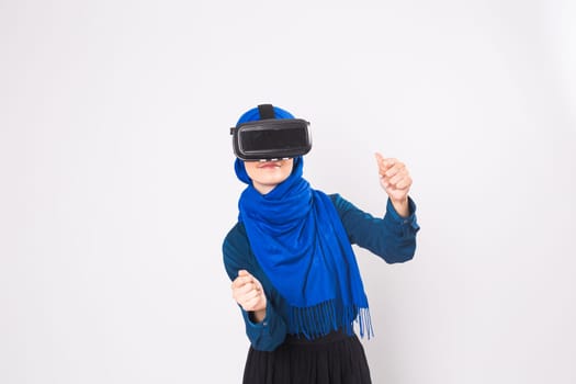 Muslim woman using VR headset. technology, vr, people and game concept.