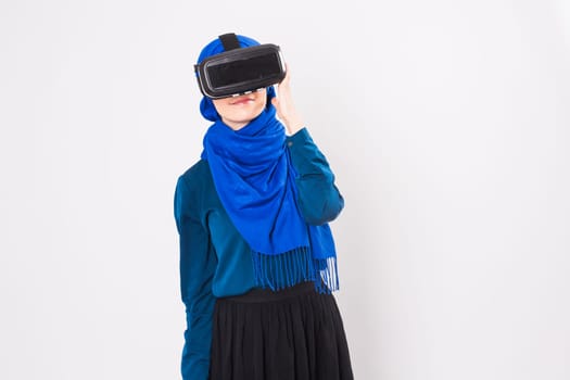 Muslim woman using VR headset. technology, vr, people and game concept.