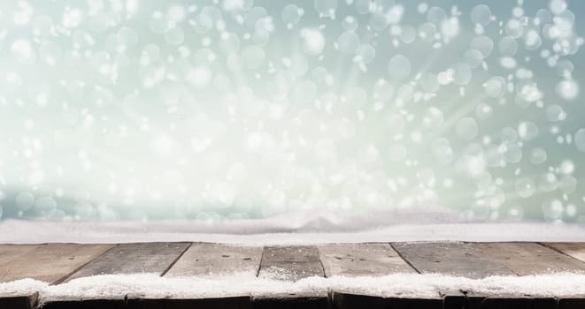 Rustic wooden table with snow and winter landscape