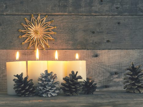 Four Advent candles are burning, fourth Advent candle burns, Christmas concept