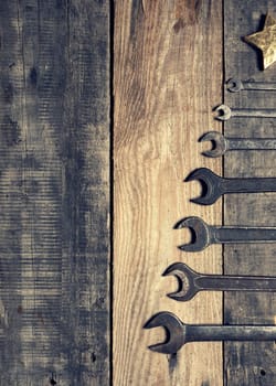 Old used wrenches as a Christmas tree shape with space for text of image, industrial Chrismas concept