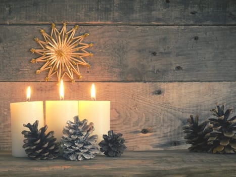 Three Advent candles are burning, third Advent Christmas concept