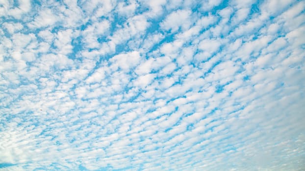 Blue sky background with clouds. Beauty clear cloudy sunshine calm bright texture. Vivid cyan landscape in spring day environment