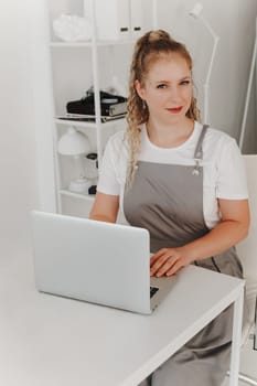 Woman Professional Manicurist at her Desk Works with a Laptop. Sign up for manicure Services, Freelancer Work Schedule