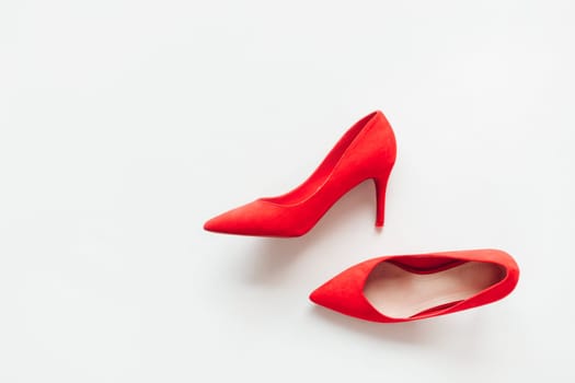 Red suede women's high-heeled shoes on a white background. Fashion