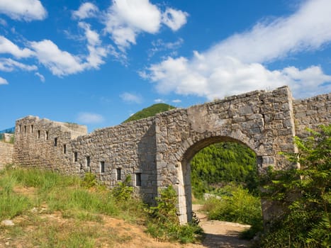 Ruins of medieval fortress Tvrdava Mogren at the shore of Adriatic sea, Montenegro.