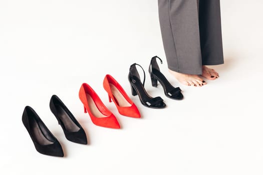 Woman choosing suitable shoes for evening or office