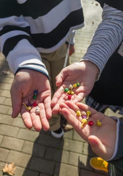 Three children show their hands full of bomblets. Sale of pyrotechnic products at Christmas season