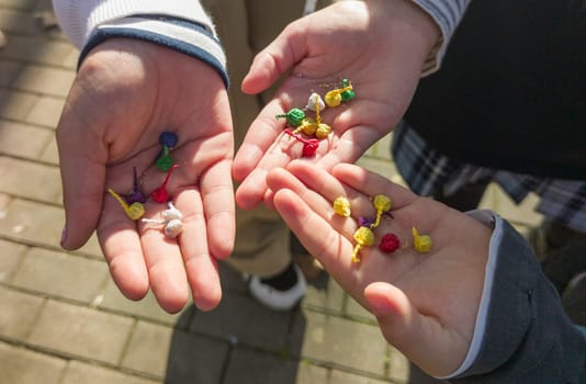 Three children show their hands full of bomblets. Sale of pyrotechnic products at Christmas season