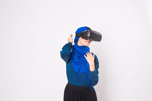 Muslim woman using VR headset. technology, vr, people and game concept.