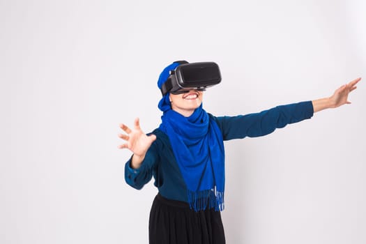 Woman with virtual reality goggles. Studio shot, gray background