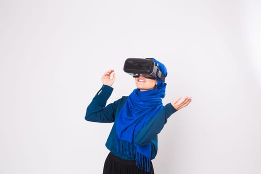 Young muslim woman with virtual reality glasses. Technology, vr, future and people concept.