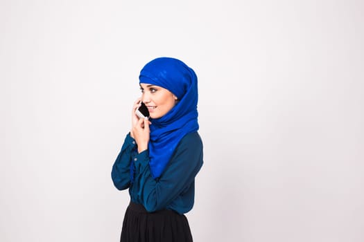 attractive modern muslim woman talking on cell phone
