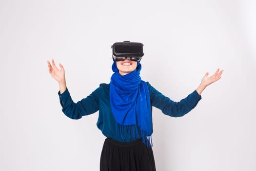 Young muslim woman with virtual reality glasses. Technology, vr, future and people concept.