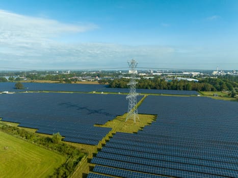 electricity pylons in the middle of a huge solar park