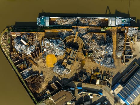 aerial view of a professional scrapyard along a canal