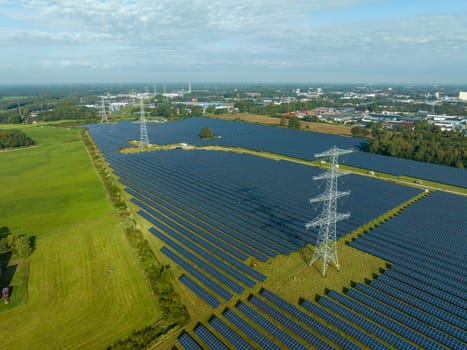 electricity pylons in the middle of a huge solar park