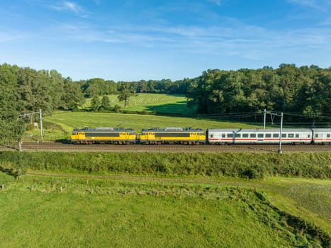 DE LUTTE, NETHERLANDS - SEPTEMBER 15, 2023: German DB passenger train with two dutch railroad (NS) locomotives in front